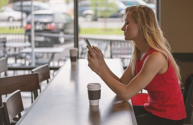 Woman using a smartphone in a cafe
