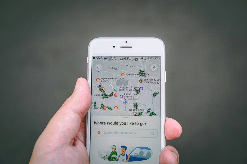 person holding a mobile device with a map for local seo