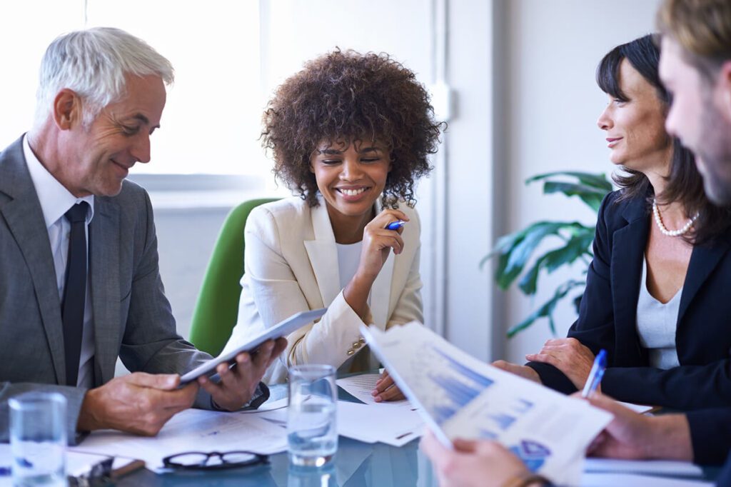 Four individuals seated at a table engaged in a discussion