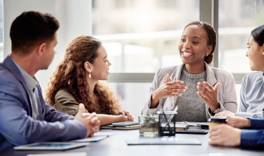 People seated around a table holding a discussion