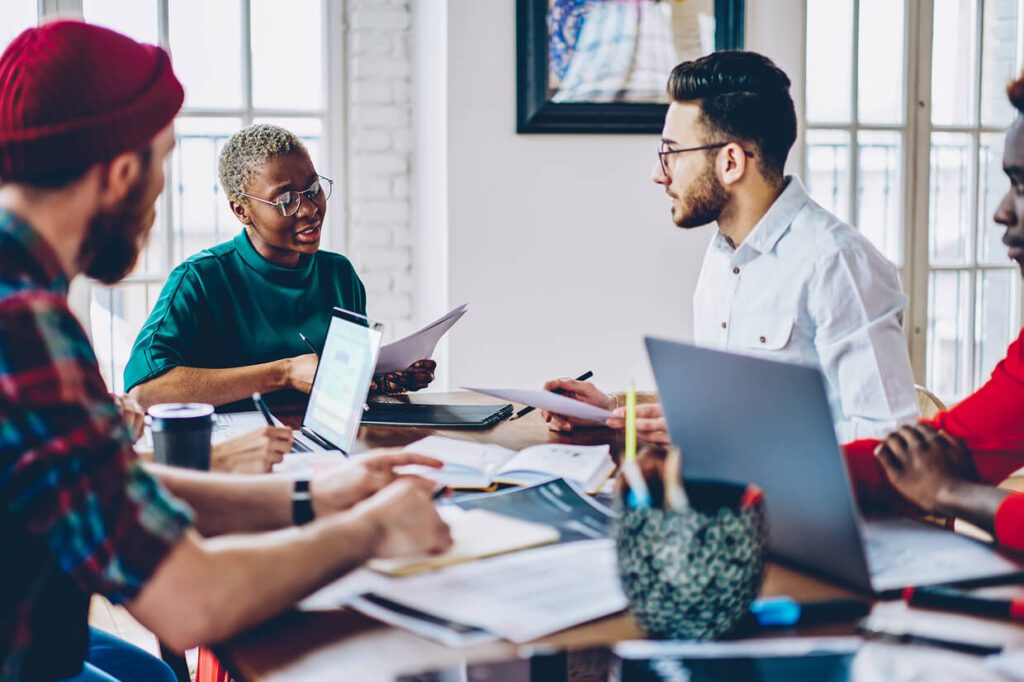 Group of people in a discussion seated around a table